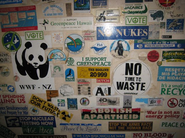 Stickers pasted on the wall by the stairs leading down to the hold on the Rainbow Warrior