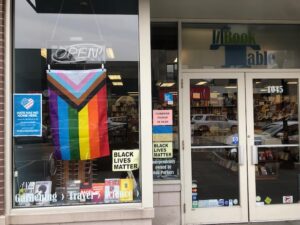 Photo of bookshop with pride flag in window